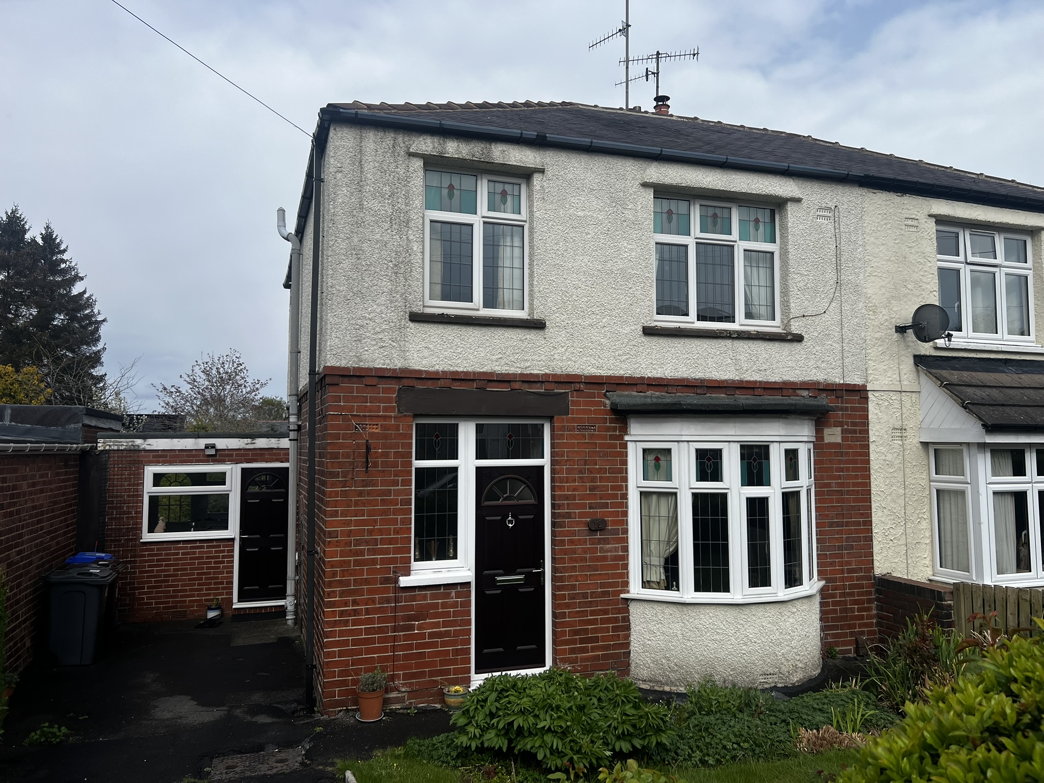 Surveyor inspecting the external walls and roof of an older property